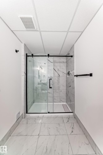 Bathroom with a marble finish shower and light marble finish floors - 4008 37 Avenue, Edmonton, AB - Indoor Photo Showing Bathroom