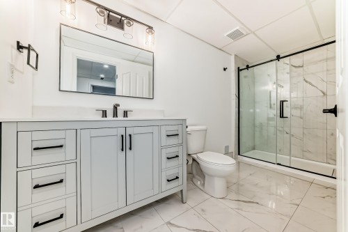 Bathroom with vanity, a marble finish shower, and a paneled ceiling - 4008 37 Avenue, Edmonton, AB - Indoor Photo Showing Bathroom