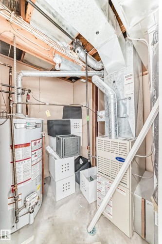 Unfinished below grade area featuring gas water heater and heating unit - 4008 37 Avenue, Edmonton, AB - Indoor Photo Showing Basement