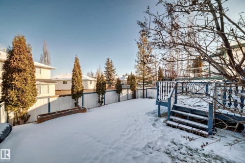 Snowy yard featuring a fenced backyard, a residential view, and a deck - 4008 37 Avenue, Edmonton, AB - Outdoor