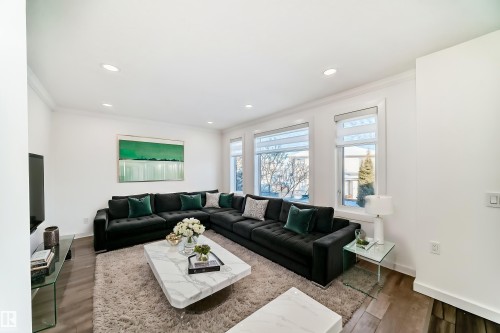 Living area featuring wood finished floors, recessed lighting, and ornamental molding - 4008 37 Avenue, Edmonton, AB - Indoor Photo Showing Living Room