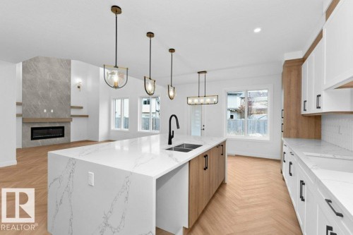 53 Lilac Bay, Spruce Grove, AB - Indoor Photo Showing Kitchen With Fireplace With Double Sink