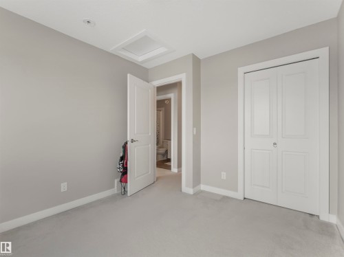 This room features a soft gray carpet, light gray walls, and white trim throughout - 725 36 Street, Edmonton, AB - Indoor
