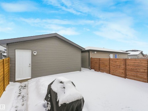 The property features a private yard with a wooden fence and a detached exterior building - 725 36 Street, Edmonton, AB - Outdoor With Exterior