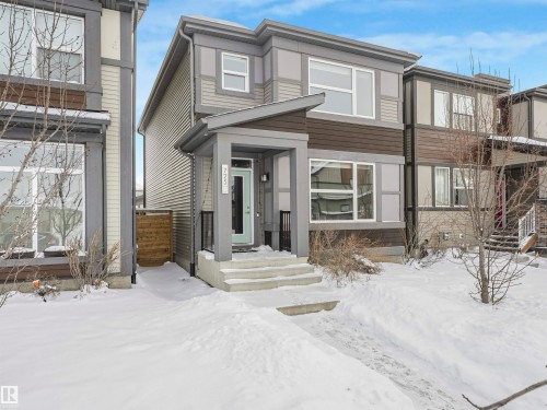 The property features a multi-toned exterior with a covered front entrance and a light-colored front door - 725 36 Street, Edmonton, AB - Outdoor With Facade