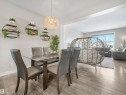 The property features an open-concept living area with light wood-look flooring and light-colored walls - 725 36 Street, Edmonton, AB  - Indoor Photo Showing Dining Room 