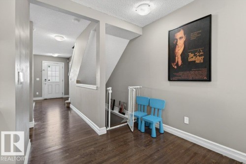 Entryway featuring rich wood-finish flooring, light gray wall paint, and white trim - 40 14621 121 Street, Edmonton, AB - Indoor Photo Showing Other Room