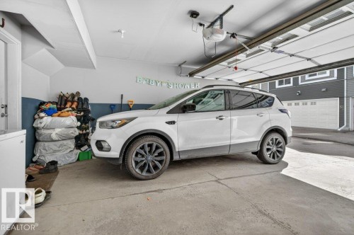 Attached garage featuring a concrete floor and an automatic garage door opener - 40 14621 121 Street, Edmonton, AB - Indoor Photo Showing Garage