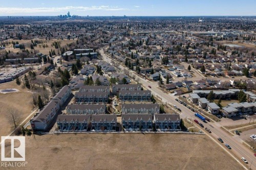 Aerial perspective showcasing a residential area with townhomes and detached properties - 40 14621 121 Street, Edmonton, AB - Outdoor With View
