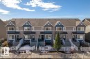 Modern townhome exteriors featuring dormer windows, covered entryways, and contrasting siding colors - 40 14621 121 Street, Edmonton, AB  -  With Facade 