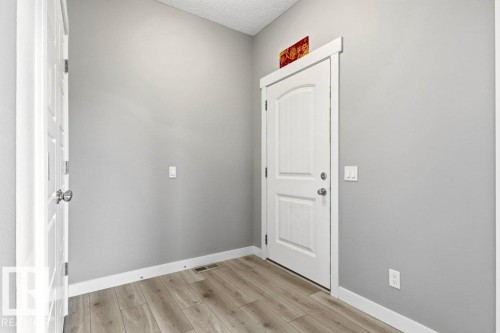Entryway featuring light wood-finish flooring, white baseboards, and neutral grey walls - 17451 77 Street, Edmonton, AB - Indoor Photo Showing Other Room