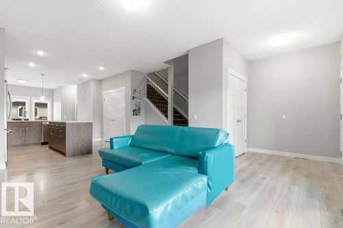 Open concept living area featuring light wood-finish flooring, recessed lighting, and a neutral wall palette - 17451 77 Street, Edmonton, AB - Indoor Photo Showing Living Room