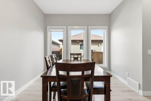 Dining area featuring light gray walls, white trim, and wood-finish flooring - 17451 77 Street, Edmonton, AB - Indoor Photo Showing Dining Room