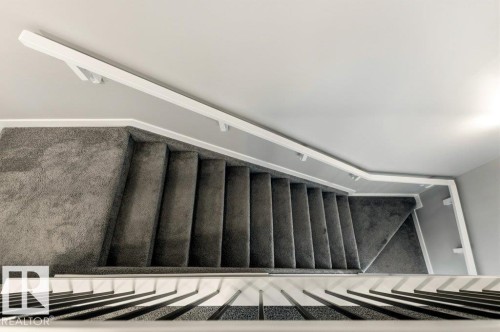 Carpeted staircase featuring a white handrail and white balusters - 17451 77 Street, Edmonton, AB - Indoor
