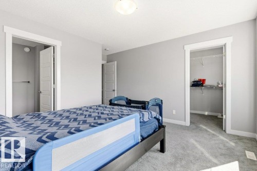Spacious bedroom featuring light gray walls, white trim, and gray carpet flooring - 17451 77 Street, Edmonton, AB - Indoor Photo Showing Bedroom