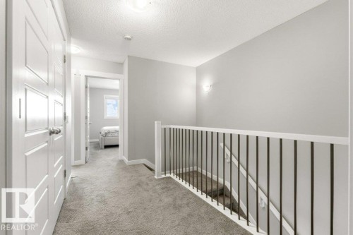 Upper-level hallway with light gray carpeting and white trim - 17451 77 Street, Edmonton, AB - Indoor Photo Showing Other Room