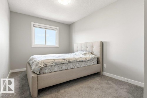 Neutral-toned room with light gray walls, white trim, and gray carpet flooring - 17451 77 Street, Edmonton, AB - Indoor Photo Showing Bedroom