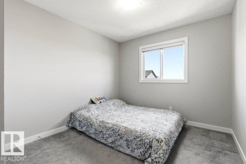Neutral wall tones with a white trim package, featuring a window and recessed ceiling light - 17451 77 Street, Edmonton, AB - Indoor Photo Showing Bedroom
