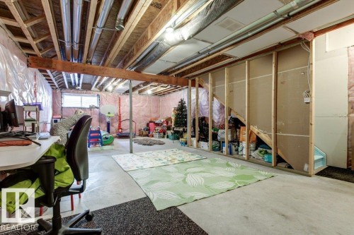 Unfinished basement with exposed ceiling joists and ductwork, featuring framed walls, concrete flooring, and a single window - 17451 77 Street, Edmonton, AB - Indoor Photo Showing Basement