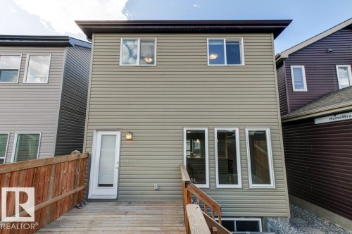 Rear exterior featuring light tan horizontal siding - 17451 77 Street, Edmonton, AB - Outdoor With Exterior