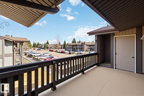 Private balcony with a neutral-toned concrete surface and dark wood railing - 5740 172 Street, Edmonton, AB - Outdoor With Exterior