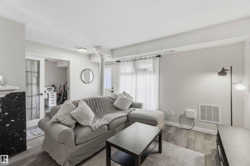 Living area featuring light wood-finish flooring and neutral wall tones - 5740 172 Street, Edmonton, AB - Indoor Photo Showing Living Room