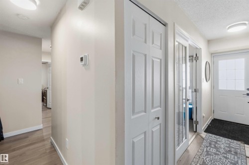 Entryway featuring a paneled door, wood-finish flooring, recessed lighting, and a thermostat - 5740 172 Street, Edmonton, AB - Indoor Photo Showing Other Room