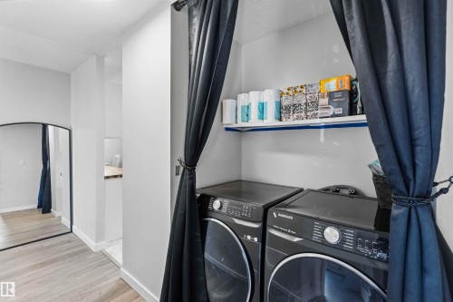 Dedicated laundry area with a white shelving unit for storage - 5740 172 Street, Edmonton, AB - Indoor Photo Showing Laundry Room