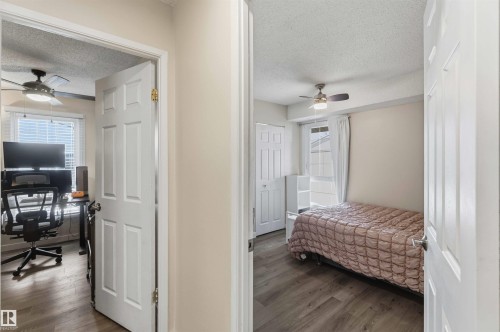 Two distinct rooms featuring wood-finish flooring and ceiling fans - 5740 172 Street, Edmonton, AB - Indoor Photo Showing Other Room