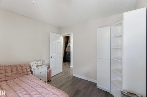 Room featuring wood-finish flooring, white baseboards, and neutral wall paint - 5740 172 Street, Edmonton, AB - Indoor Photo Showing Bedroom