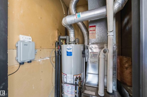 Utility closet featuring a water heater, furnace, and exposed ductwork - 5740 172 Street, Edmonton, AB - Indoor Photo Showing Basement