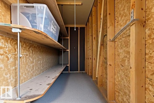 Utility space featuring exposed wood framing, a dark wall panel, and a gray floor - 5740 172 Street, Edmonton, AB - Indoor Photo Showing Other Room