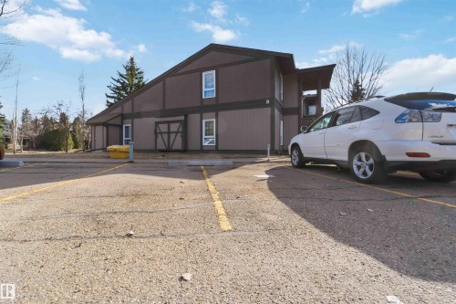 Multi-story building featuring a brown siding exterior, a gabled roofline, and white-framed windows - 5740 172 Street, Edmonton, AB - Outdoor