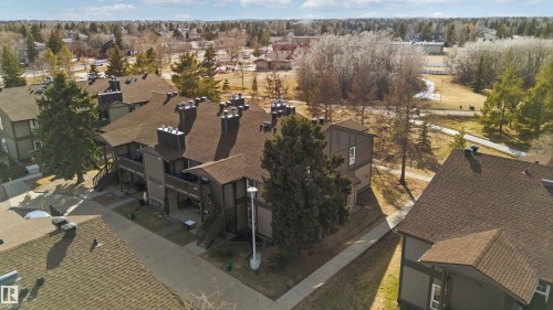 Multi-unit residential structure featuring dark siding and brown shingle roofing - 5740 172 Street, Edmonton, AB - Outdoor With View