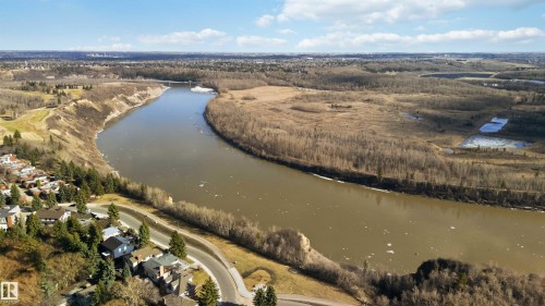 Winding river through a natural landscape with distant residential areas - 5740 172 Street, Edmonton, AB - Outdoor With View