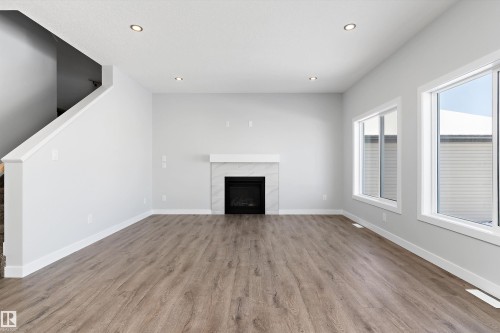 76 Maple Crescent, Gibbons, AB - Indoor Photo Showing Living Room With Fireplace