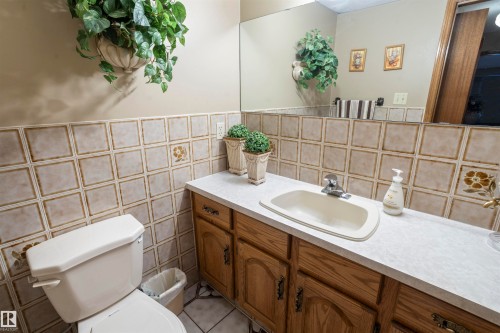 Bathroom vanity with a light-colored countertop and a built-in sink - 9831 158 Avenue, Edmonton, AB - Indoor Photo Showing Bathroom