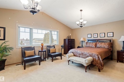 Vaulted ceiling bedroom with a large window featuring horizontal blinds - 9831 158 Avenue, Edmonton, AB - Indoor Photo Showing Bedroom