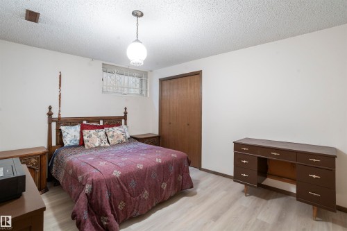 Room featuring light wood-finish flooring, white walls, and a textured ceiling - 9831 158 Avenue, Edmonton, AB - Indoor Photo Showing Bedroom