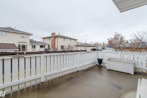 Spacious outdoor patio area featuring a white picket fence perimeter - 9831 158 Avenue, Edmonton, AB - Outdoor