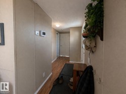 A welcoming entryway featuring hardwood flooring and light-toned walls - 