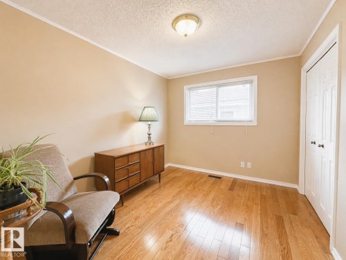 Light wood-finish flooring complements the neutral wall color in this room - 11139 30 Avenue, Edmonton, AB - Indoor Photo Showing Other Room