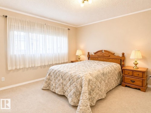 Wall-to-wall carpeting in a neutral tone, complemented by light-colored walls - 11139 30 Avenue, Edmonton, AB - Indoor Photo Showing Bedroom