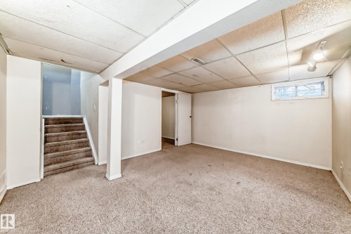 Spacious room with carpeted flooring, white walls, and a window providing natural light - 8217 182 Street Nw, Edmonton, AB - Indoor
