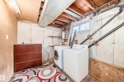 The utility area features a washing machine and dryer, exposed ceiling joists, and a window - 