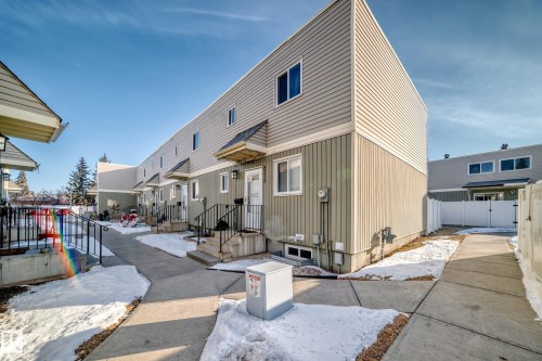 The property features a multi-story exterior with light-colored siding and a contrasting darker lower level - 8217 182 Street Nw, Edmonton, AB - Outdoor