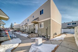 The property features a multi-story exterior with light-colored siding and a contrasting darker lower level - 