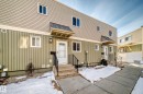 The property features vertical siding on the lower level and horizontal siding on the upper level, with a white entry door and a covered porch - 8217 182 Street Nw, Edmonton, AB  - Outdoor 