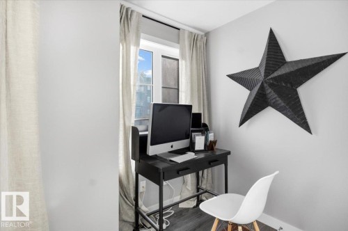 This room features a window with curtains, light gray walls, and dark flooring - 211 5029 Edgemont Boulevard, Edmonton, AB - Indoor Photo Showing Office
