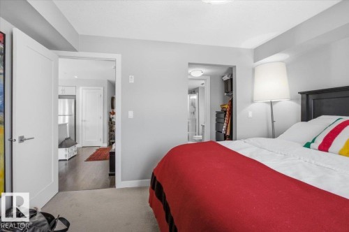 This bedroom features light gray walls and a light-colored carpet - 211 5029 Edgemont Boulevard, Edmonton, AB - Indoor Photo Showing Bedroom